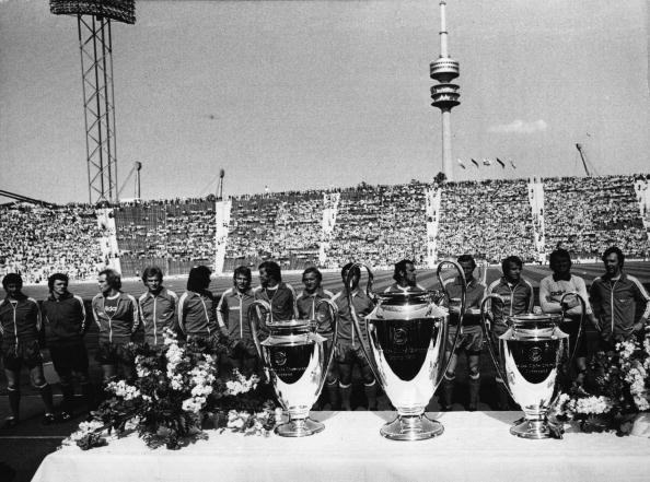  Winners for the third time.. (Photo: Keystone/Getty Images) 12th May 1976:  Winners for the third time, the players of Bayern Munich football club stand in front of the three cups in the Munich Olympic stadium, with the original in the middle.  (Photo by Keystone/Getty Images)